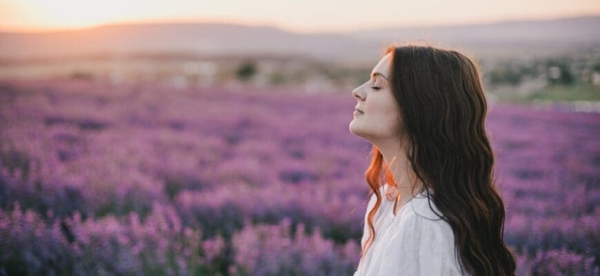 Young,Beautiful,Woman,In,White,Dress,Enjoying,Flower,Fragrance,On